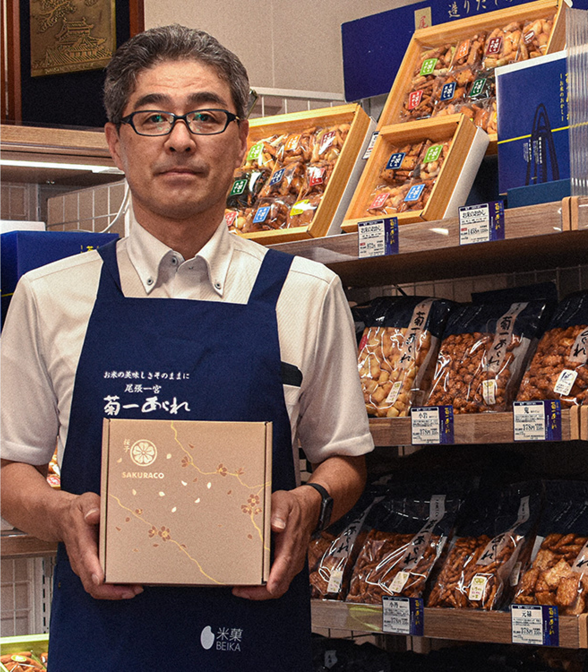 Japanese snack maker Kikuichi Arare President Hajime Watanabe holding a Sakuraco Japanese snack box.